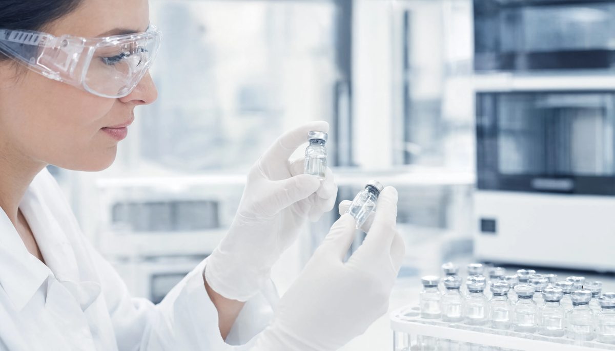 Scientist inspecting a peptide vial